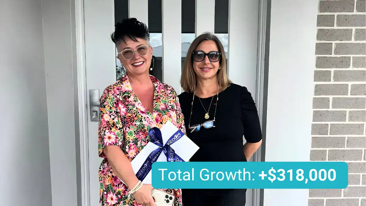 Woman standing with a client in front of a home holding a gift box, celebrating $318,000 property growth.